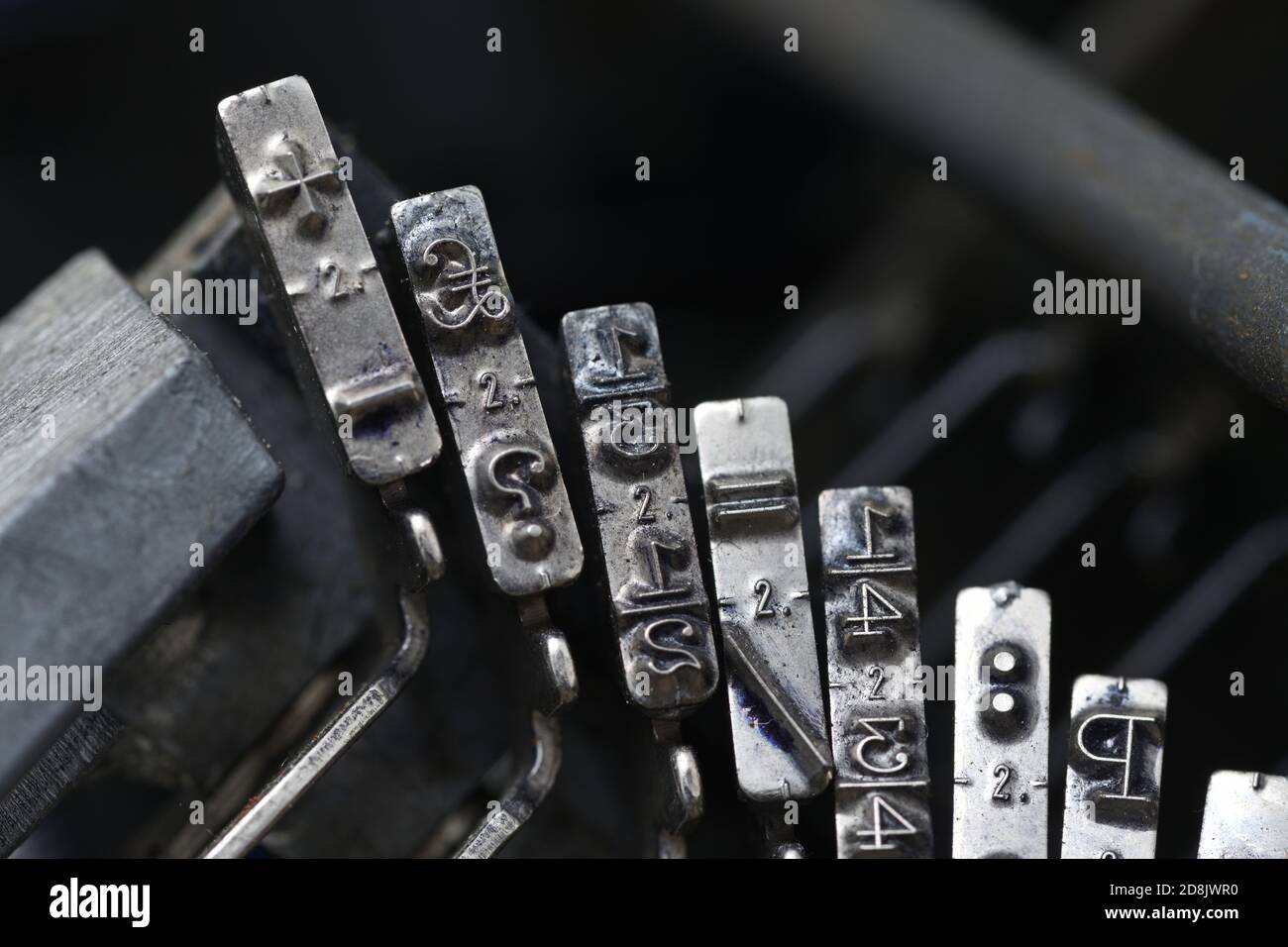 details of typewriter hammers showing symbols of a one third fraction, pound sign, question mark, addition and subtraction signs Stock Photo
