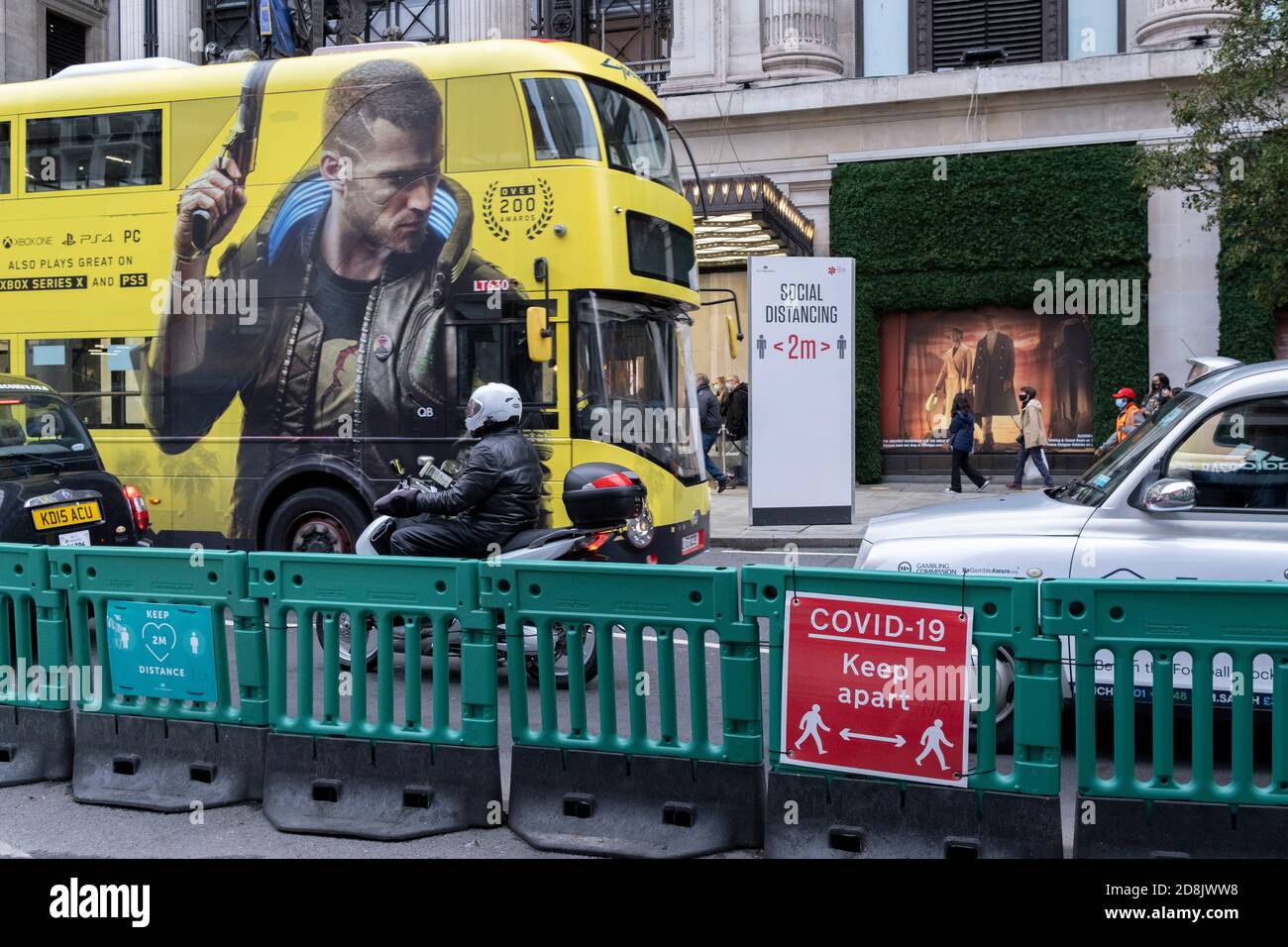 Two-metre social distancing signs advise Oxford Street shoppers to keep apart outside Selfridges, according to government guidelines during the second wave of the UK Coronavirus pandemic, on 30th October 2020, in London, England. Stock Photo