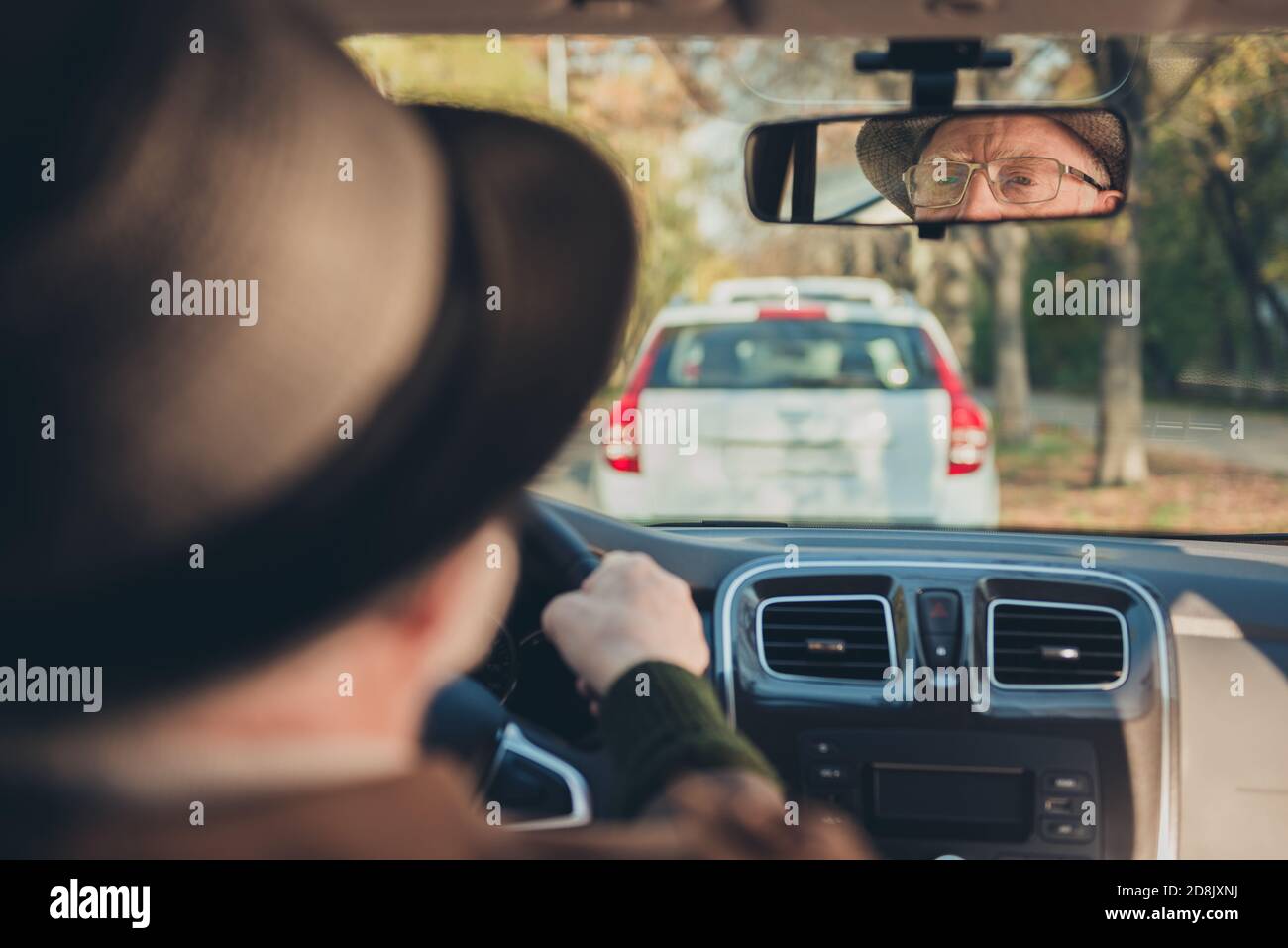 Photo of retired old man drive sit seat reflecting rare view mirror look road wear brown jacket headwear spectacles inside car Stock Photo