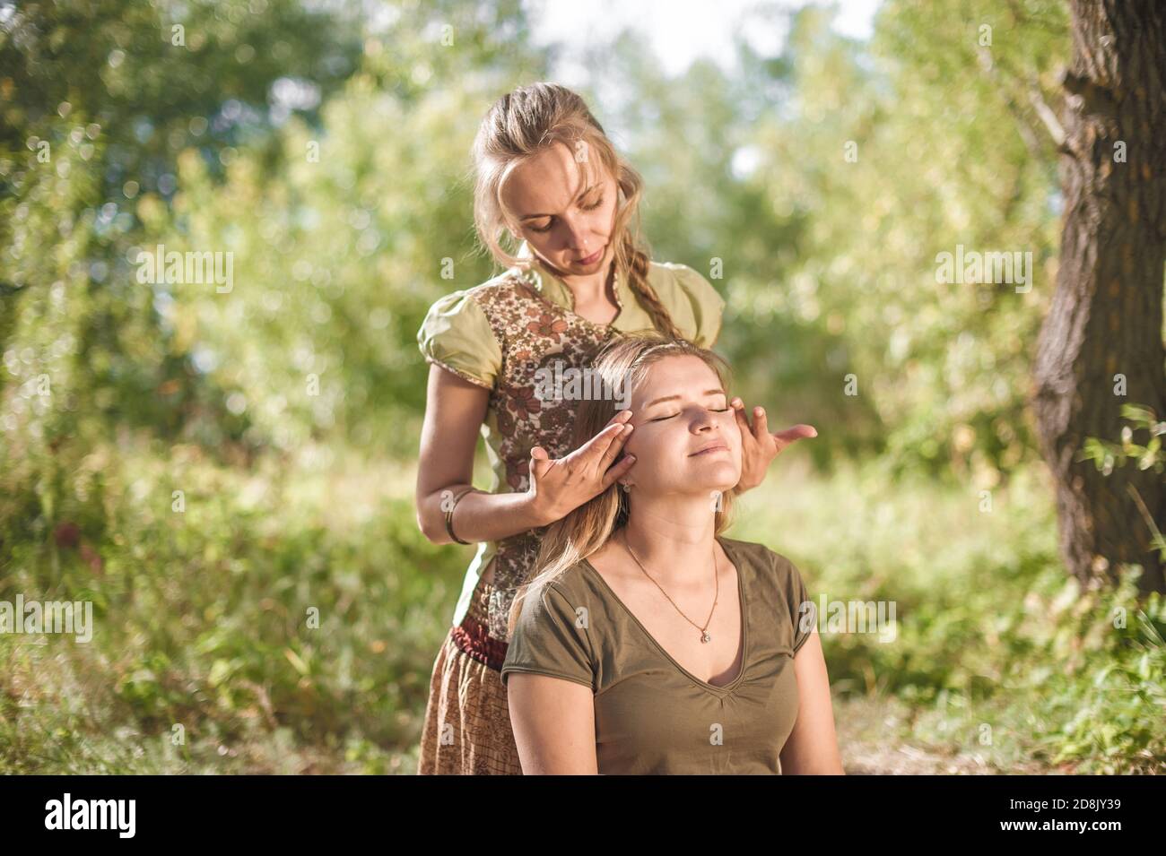 Master massage adequately performs a great massage outside. Stock Photo