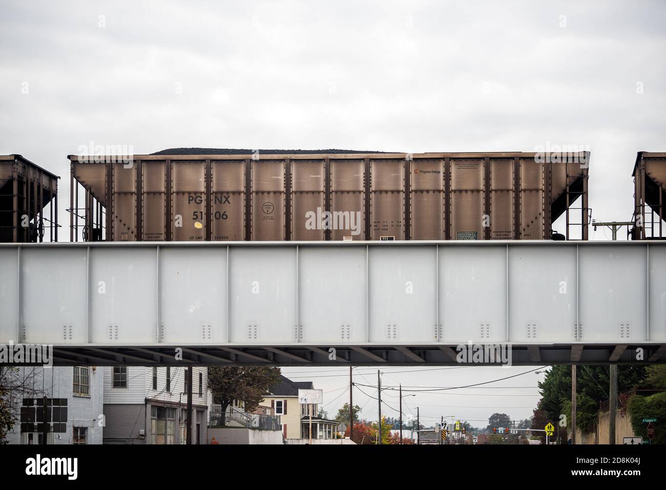Waynesboro, USA - October 27, 2020: Industrial railcars freight car on bridge in small Virginia town city with coal filled train transportation Stock Photo
