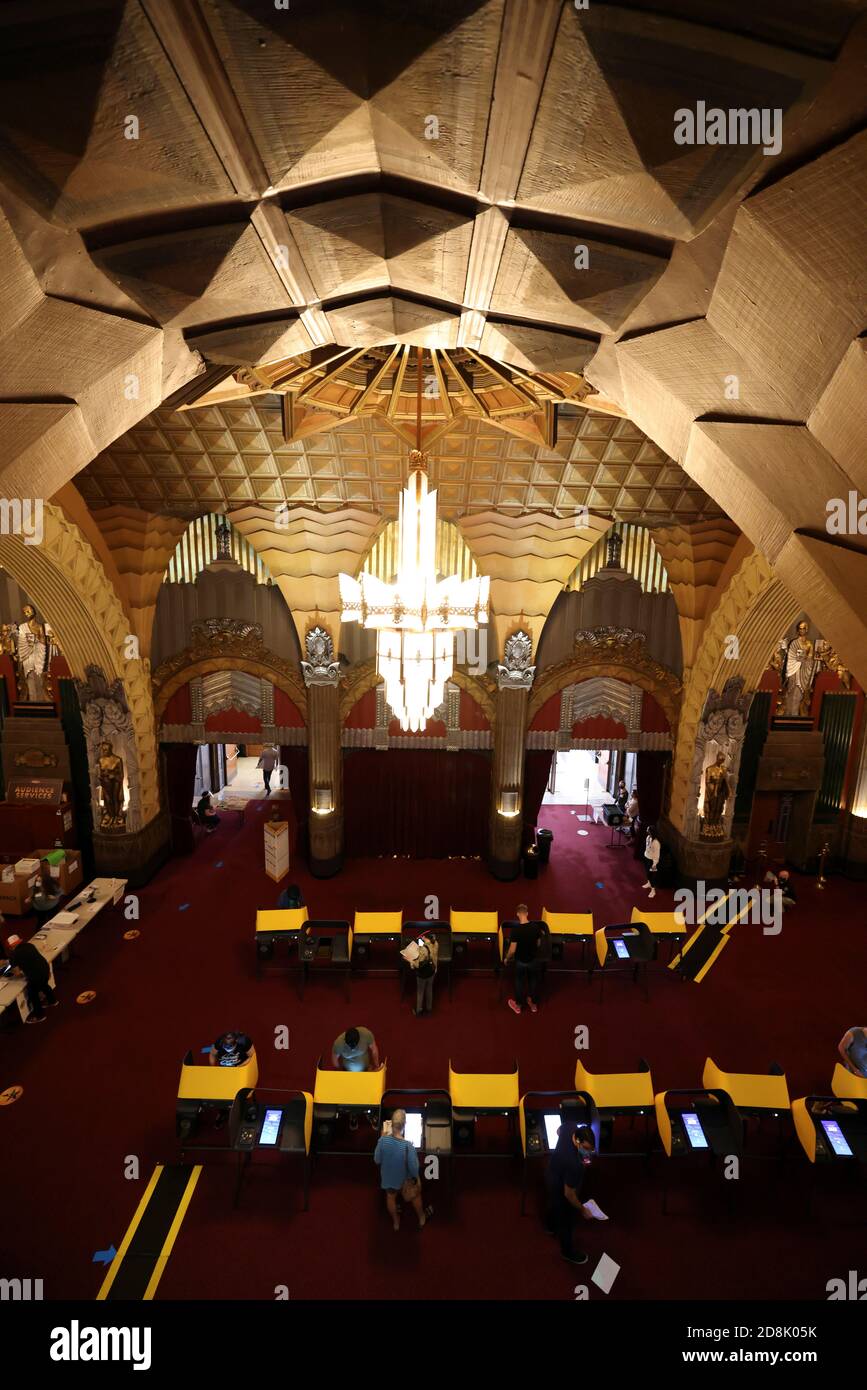 People vote at the Pantages Theater, during the global outbreak of the coronavirus disease (COVID-19), in Hollywood, Los Angeles, California, U.S., October 30, 2020. REUTERS/Lucy Nicholson Stock Photo