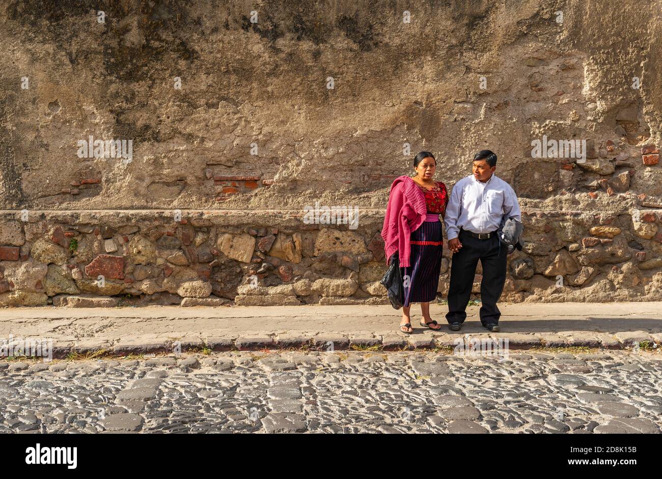 A couple of Maya guatemalan people chatting in a street of Antigua, Guatemala. Stock Photo