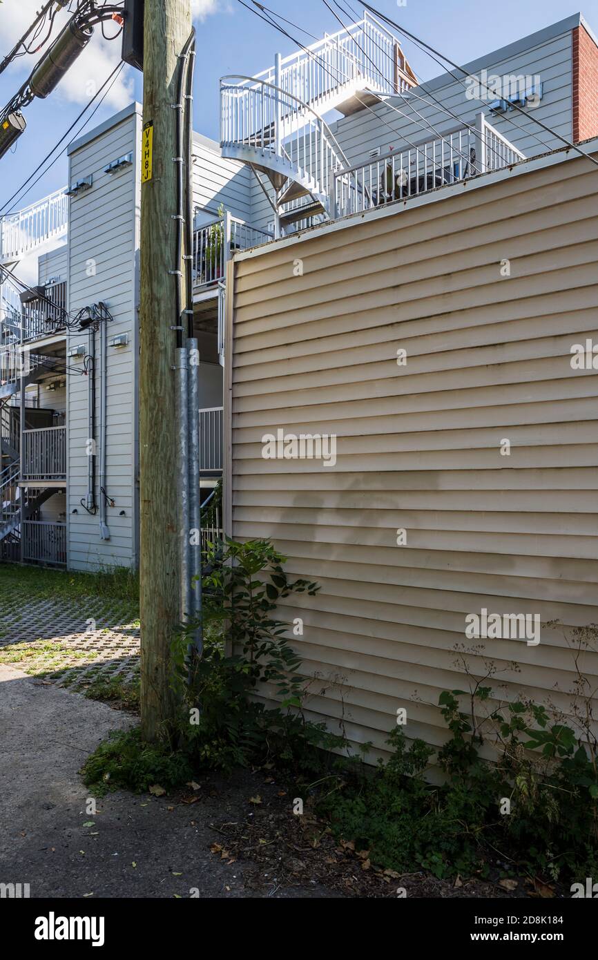 Wires and building stairways in a residential area of Hochelaga, Montreal, QC, Canada Stock Photo