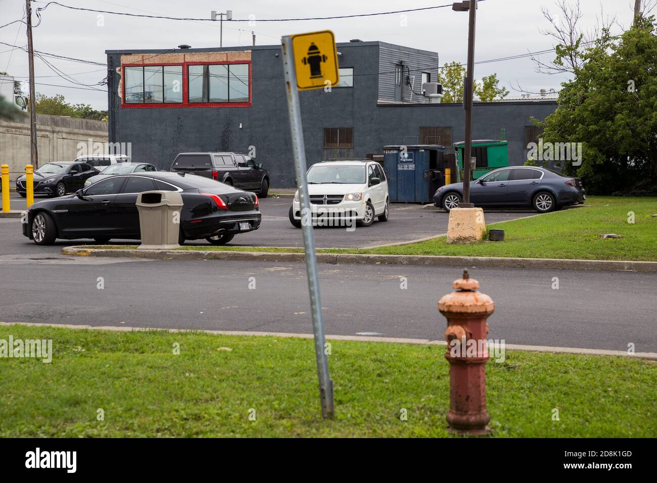 Fire hydrant and sign near a parking lot in Longueuil, Quebec, Canada