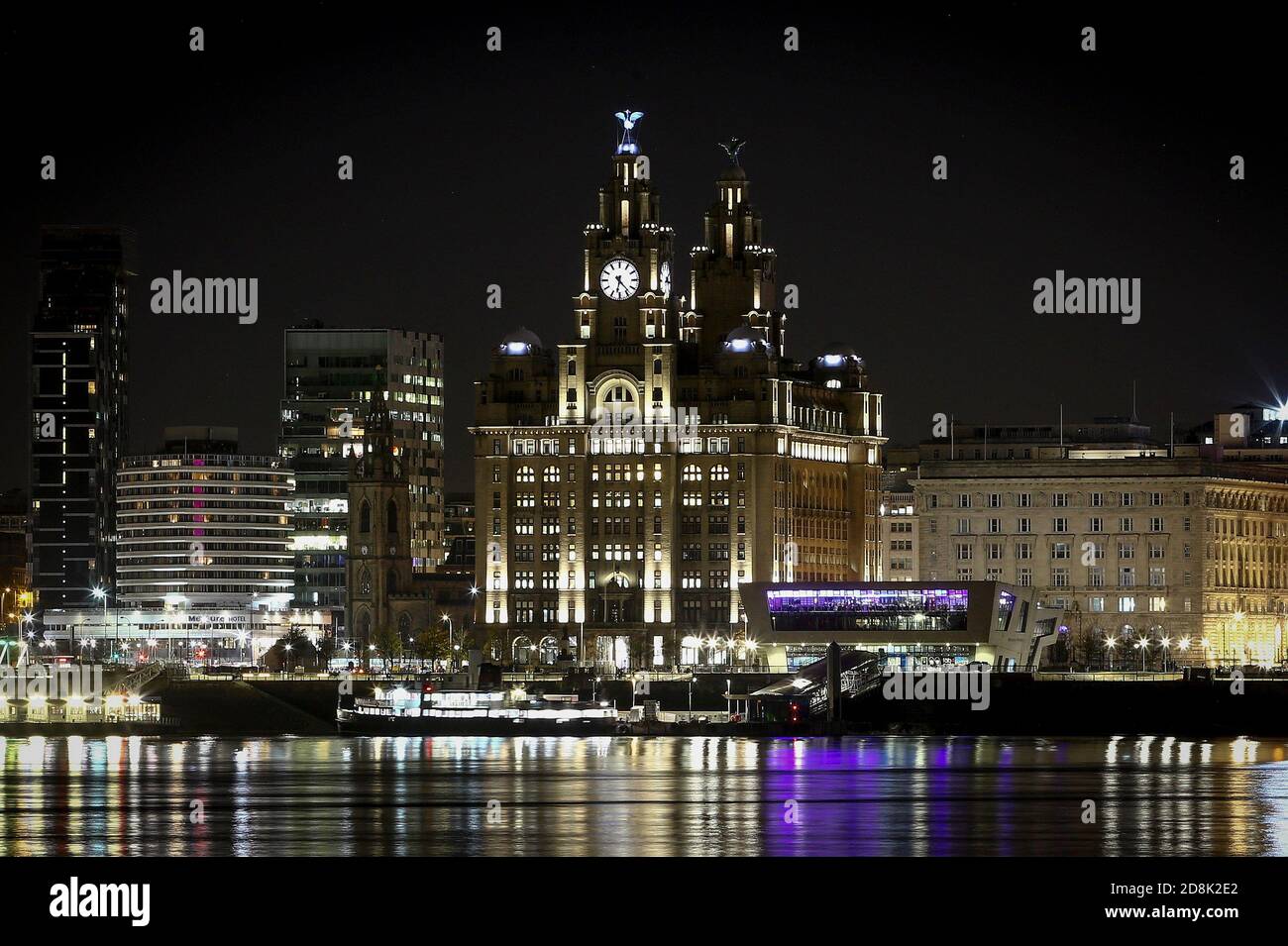 General night time view of the Liverpool waterfront and Liver Building taken from the Wirral side of the river Stock Photo