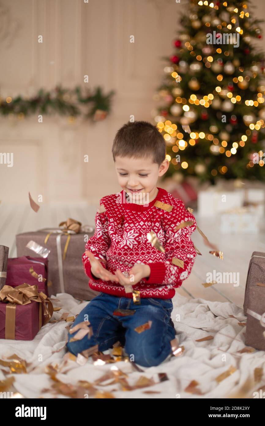 Christmas portrait little kid in confetti, teen boy wearing a red ...