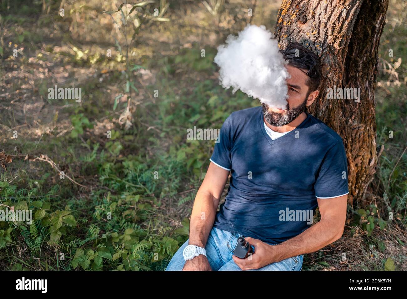 Stylish smoking an electronic smoke outside. to smoking Stock Photo - Alamy