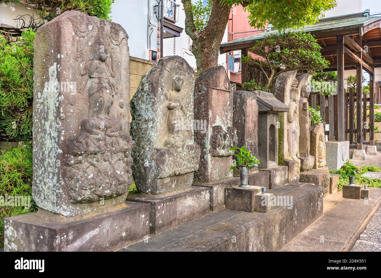 tokyo, japan - october 30 2020: Kōshintō carved stones from Taoist Buddhism depicting the blue-faced king of light Shōmen Kongō Myōō symbol of diamond Stock Photo