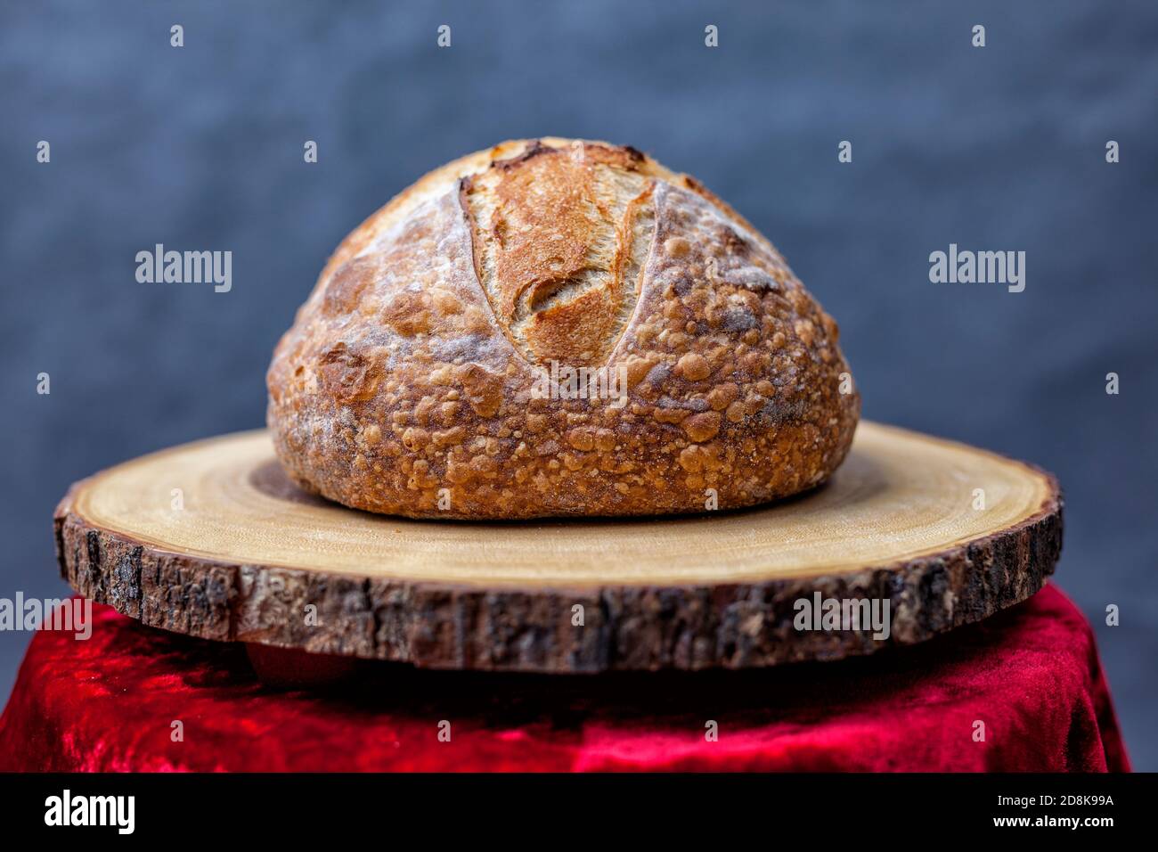Artisan loaf of traditional Homemade sourdough Boule bread with crust on a wooden board Stock Photo