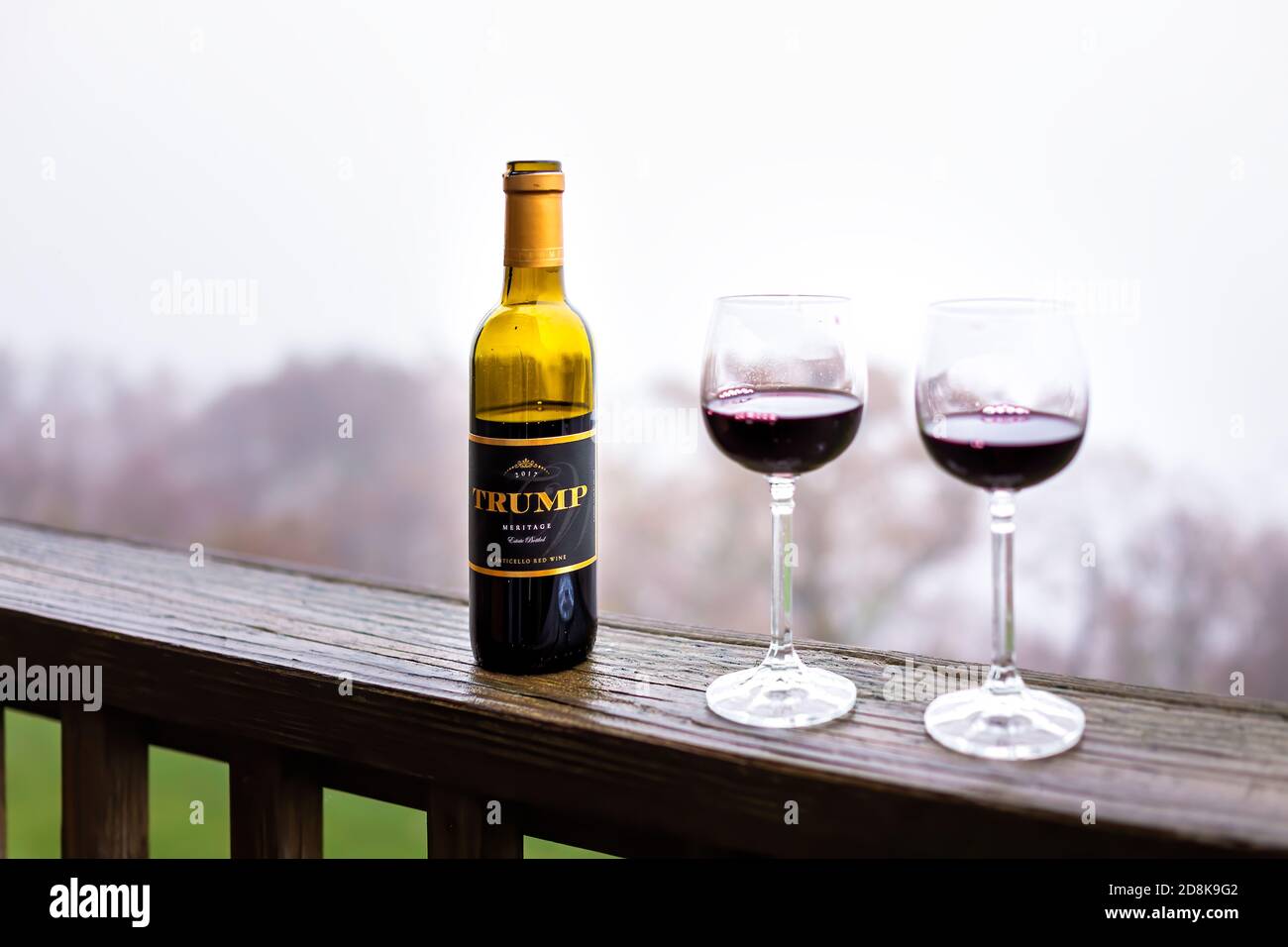 Roseland, Virginia - October 25, 2020: Closeup of Meritage red wine bottle with sign label text for Trump from famous winery in Virginia with empty gl Stock Photo