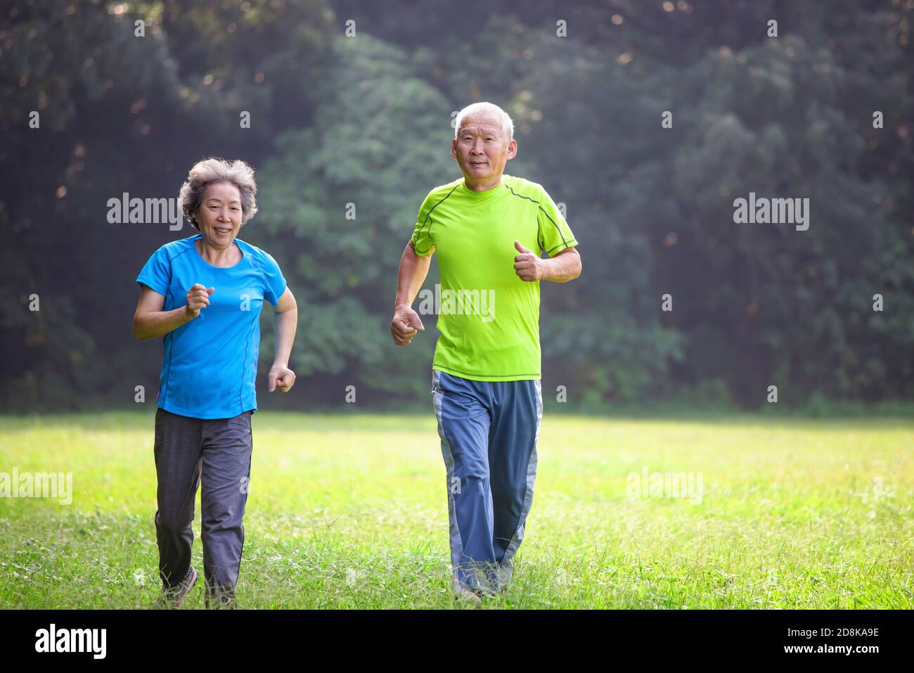 Asian Senior Couple jogging in the nature park Stock Photo - Alamy