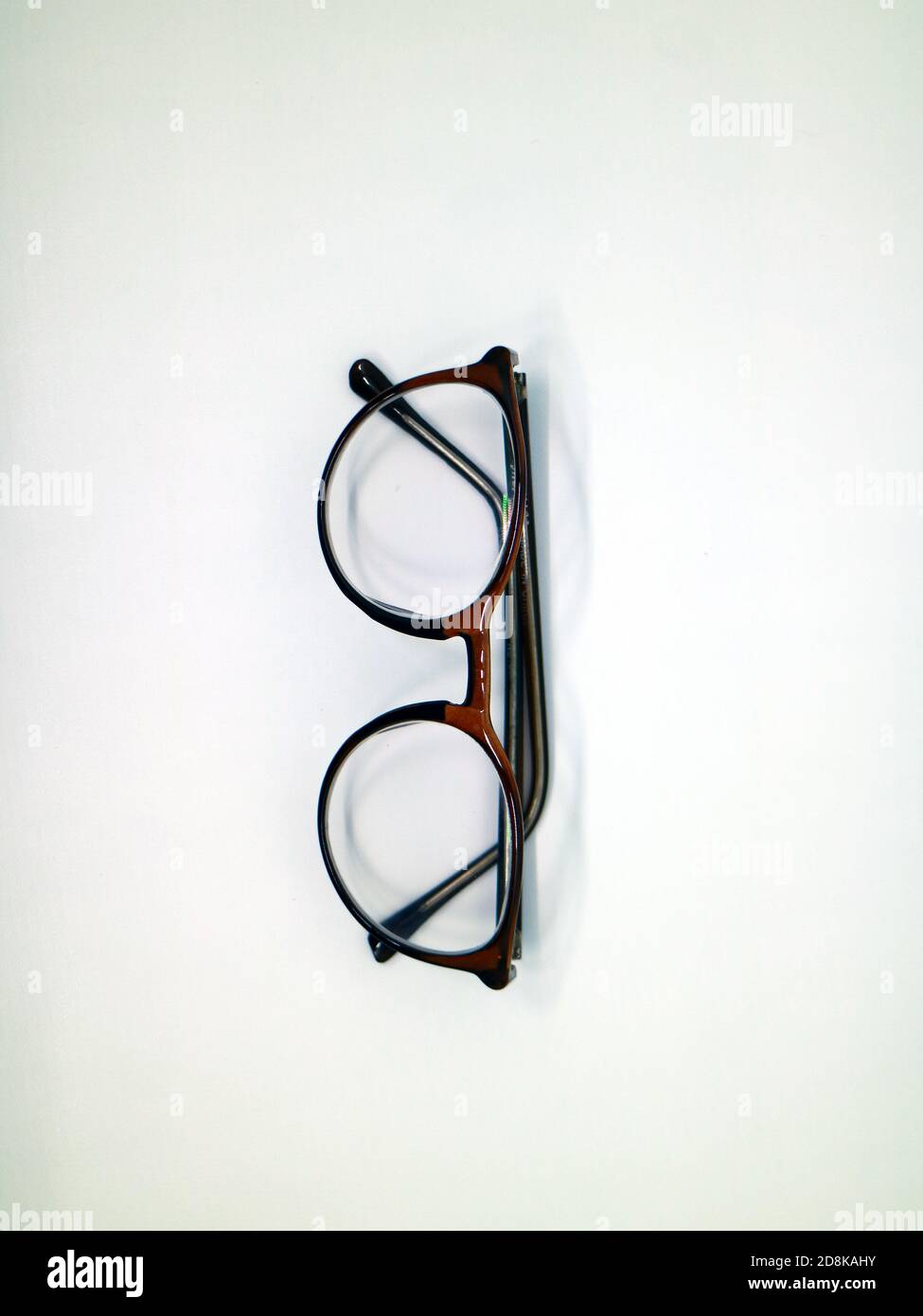 Brown glasses on white background Stock Photo - Alamy