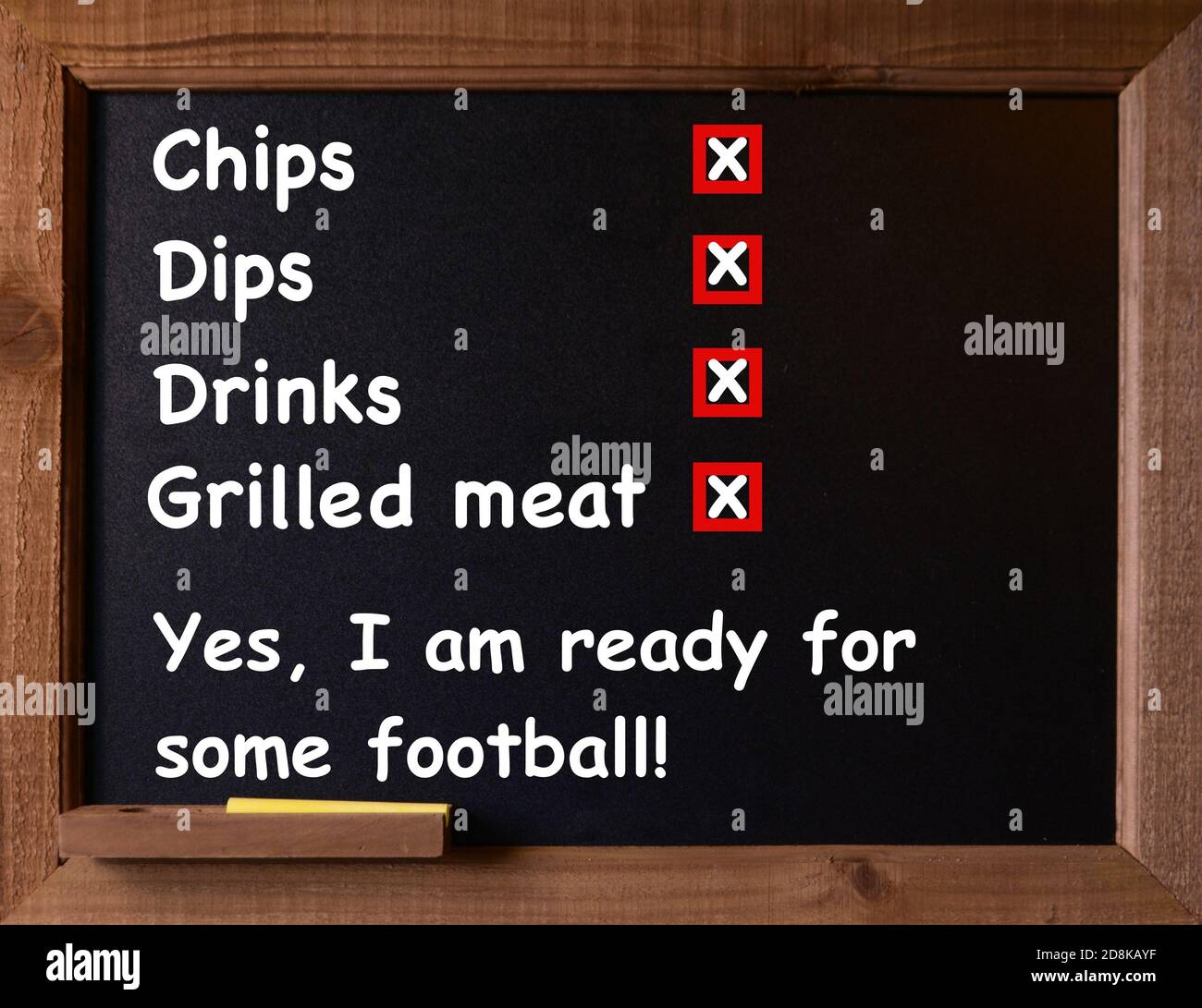 Chalkboard with a list of items needed to enjoy the Football Game Stock Photo