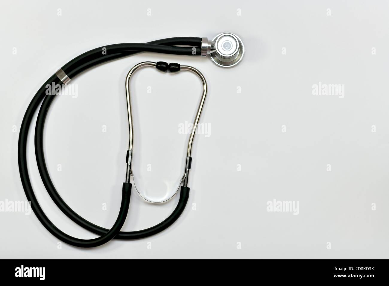 Medical metal stethoscope with acoustic head, binaural tubes, headband and earmolds.  Stock Photo