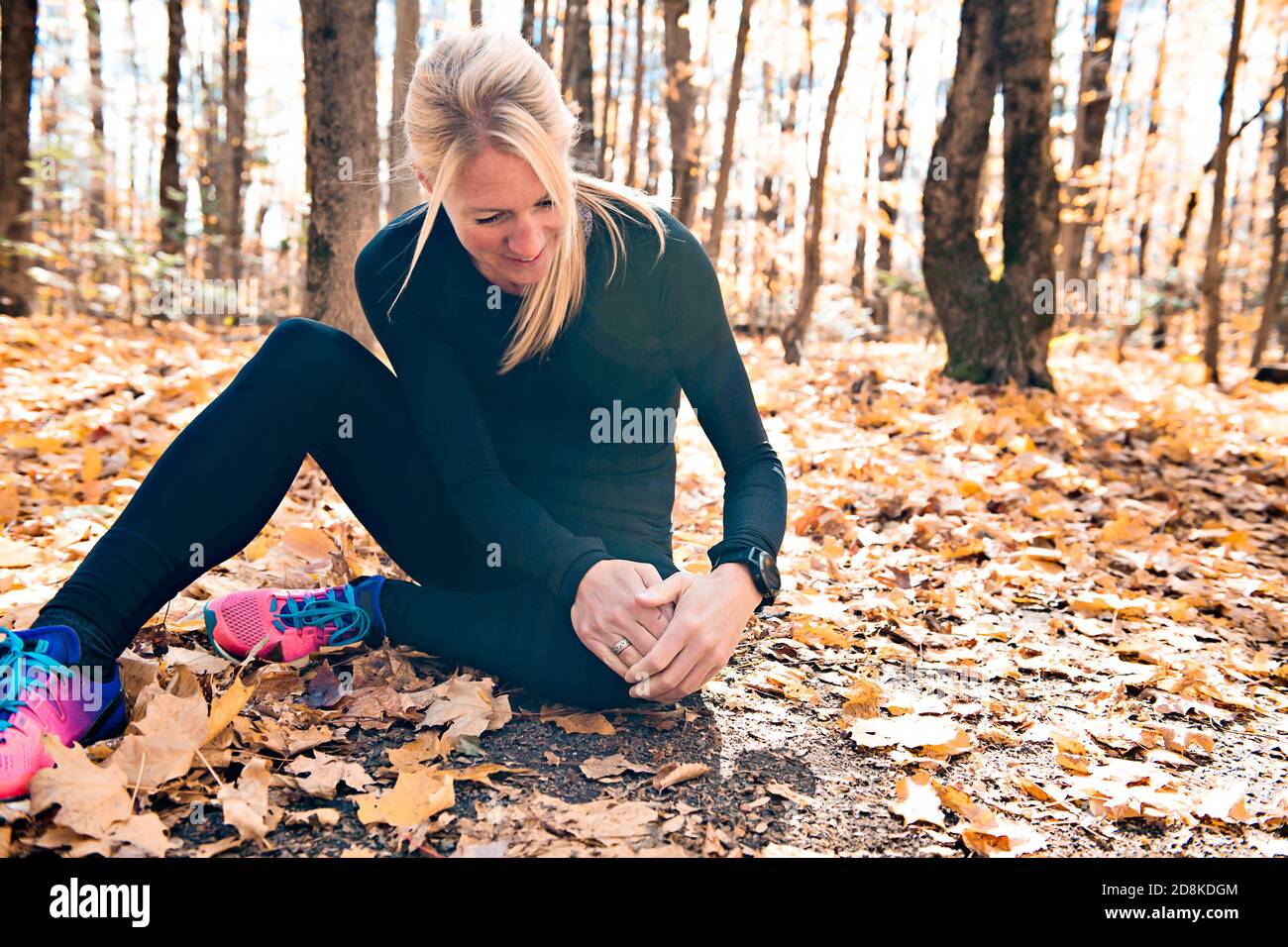 A Female runner knee injury and pain. Stock Photo