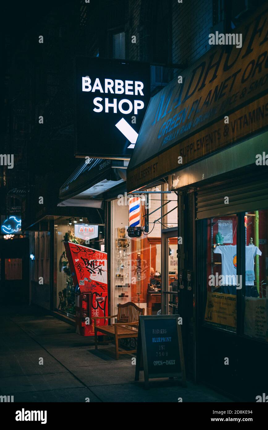 Barber shop sign at night in SoHo, Manhattan, New York City Stock Photo