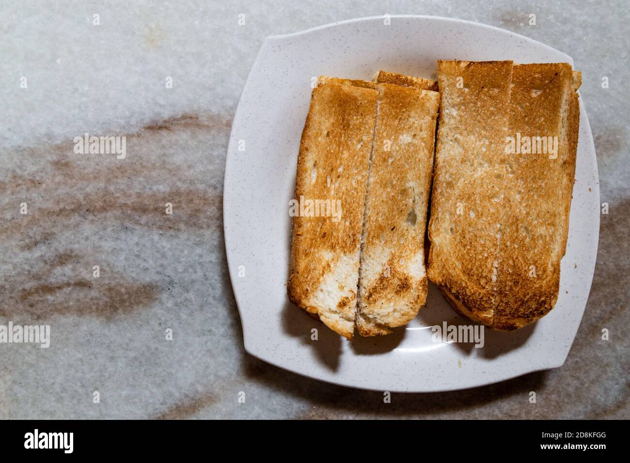 Overhead view on toast bread in traditional Chinese style with butter and kaya Stock Photo