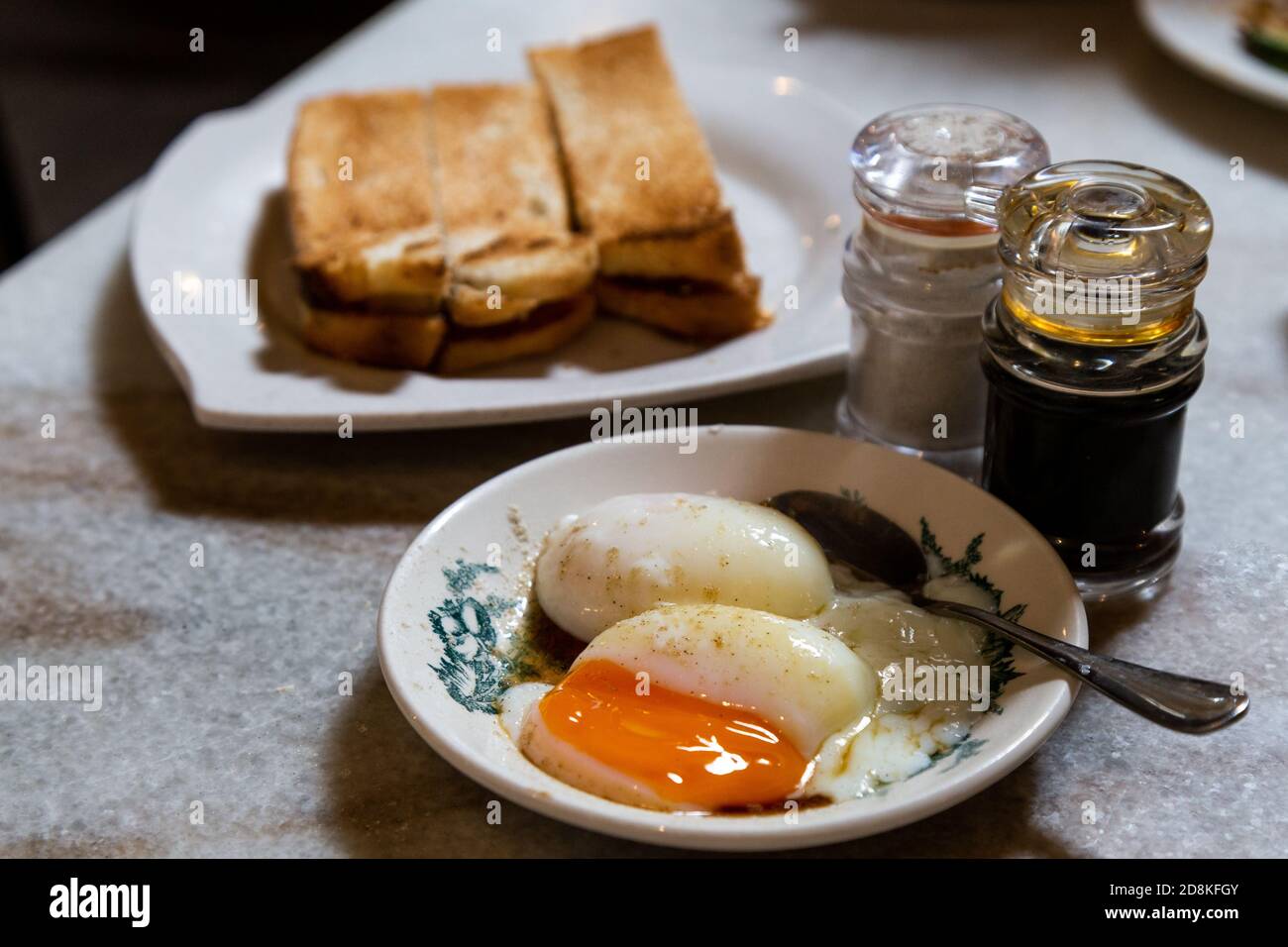 Half boiled eggs, coffee, toast bread, popular Chinese style breakfast in Malaysia Stock Photo