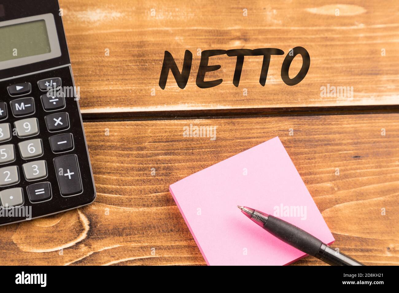 Business desk with paper, pen, and calculator with german text netto