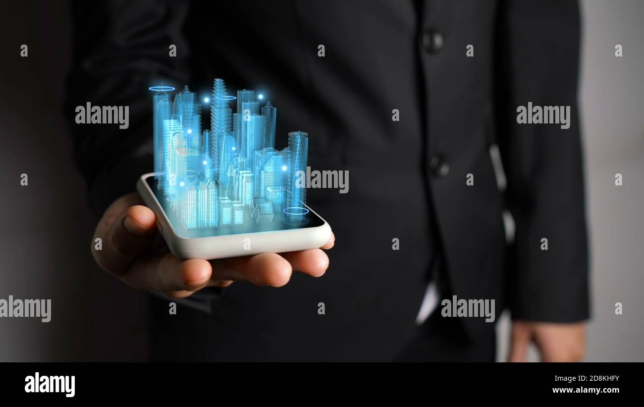 Businessman holds 3D city model showing augmented reality technology ...