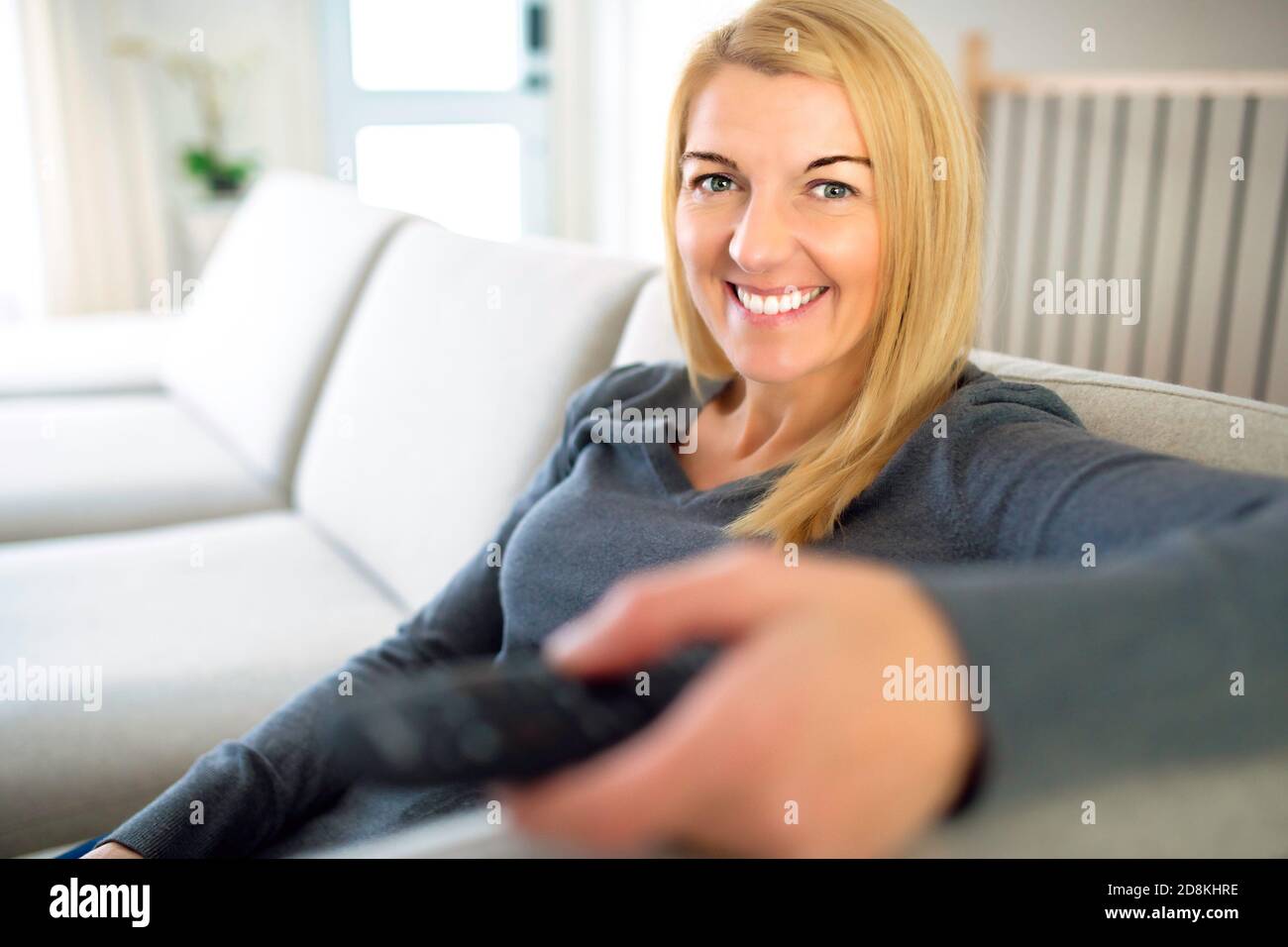 watching tv woman enjoying rest on comfortable sofa, calm attractive