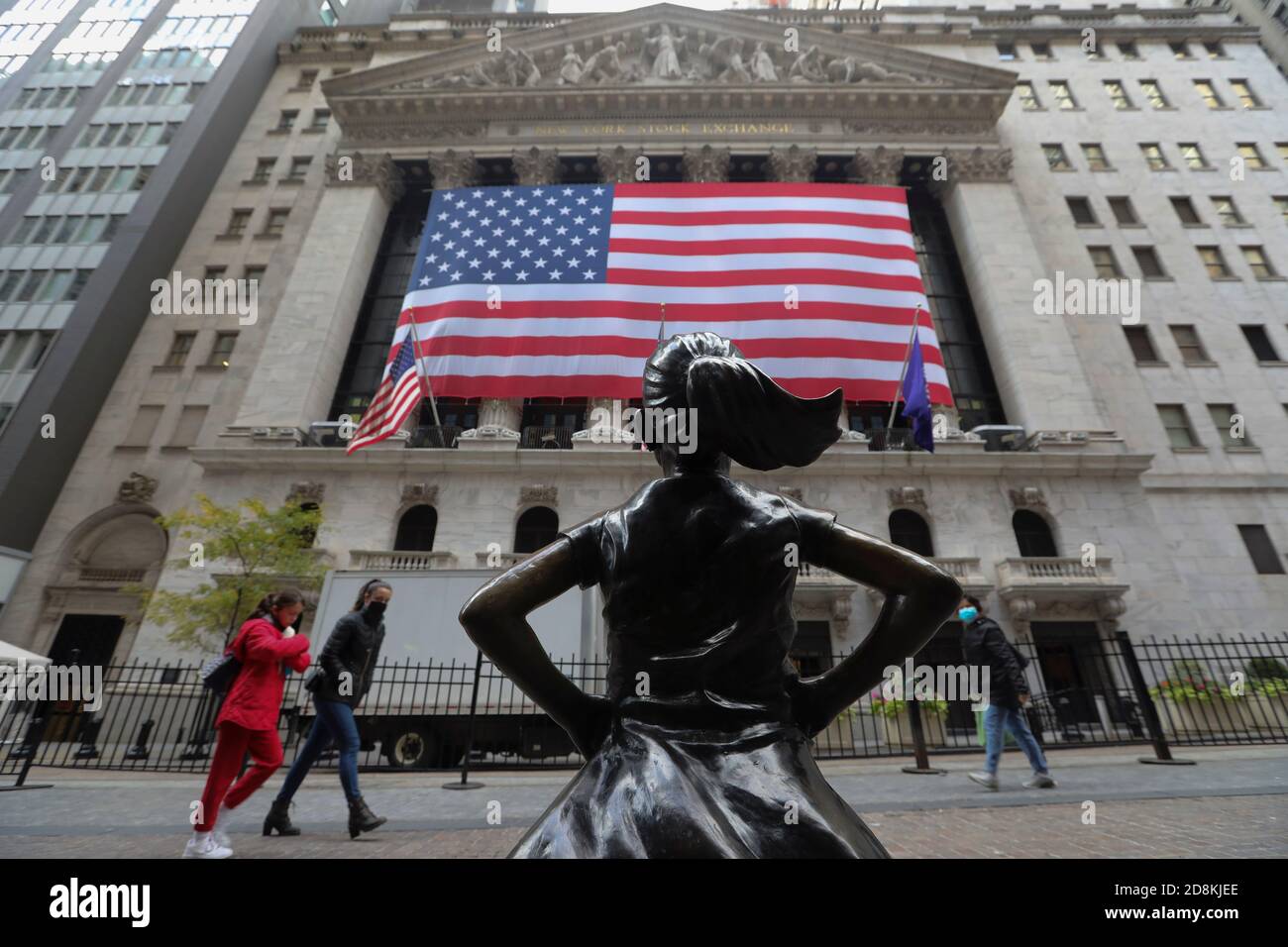 New York, USA. 30th Oct, 2020. Pedestrians walk past the New York Stock Exchange in New York, the United States, Oct. 30, 2020. U.S. stocks closed lower on Friday, as a pronounced slide in tech sector weighed on the market. The Dow Jones Industrial Average fell 157.51 points, or 0.59 percent, to 26,501.60. The S&P 500 was down 40.15 points, or 1.21 percent, to 3,269.96. The Nasdaq Composite Index shed 274.00 points, or 2.45 percent, to 10,911.59. Credit: Wang Ying/Xinhua/Alamy Live News Stock Photo