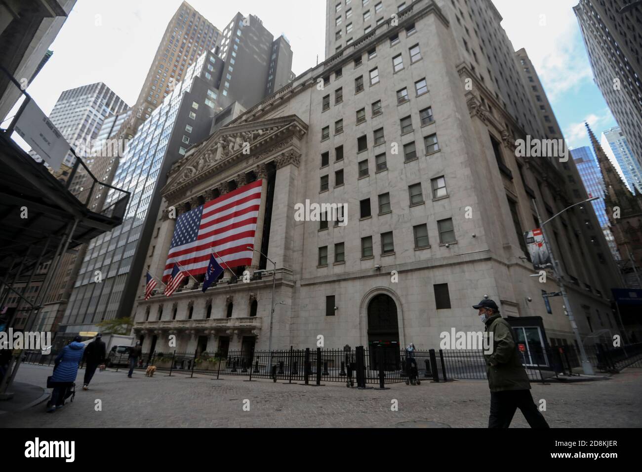 New York, USA. 30th Oct, 2020. Pedestrians walk past the New York Stock Exchange in New York, the United States, Oct. 30, 2020. U.S. stocks closed lower on Friday, as a pronounced slide in tech sector weighed on the market. The Dow Jones Industrial Average fell 157.51 points, or 0.59 percent, to 26,501.60. The S&P 500 was down 40.15 points, or 1.21 percent, to 3,269.96. The Nasdaq Composite Index shed 274.00 points, or 2.45 percent, to 10,911.59. Credit: Wang Ying/Xinhua/Alamy Live News Stock Photo
