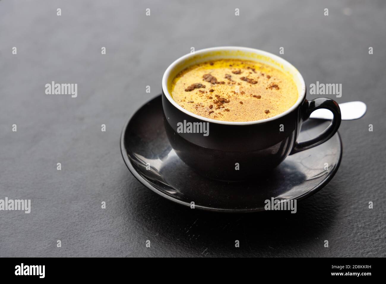 Serving of aromatic turmeric black coffee against dark table Stock ...