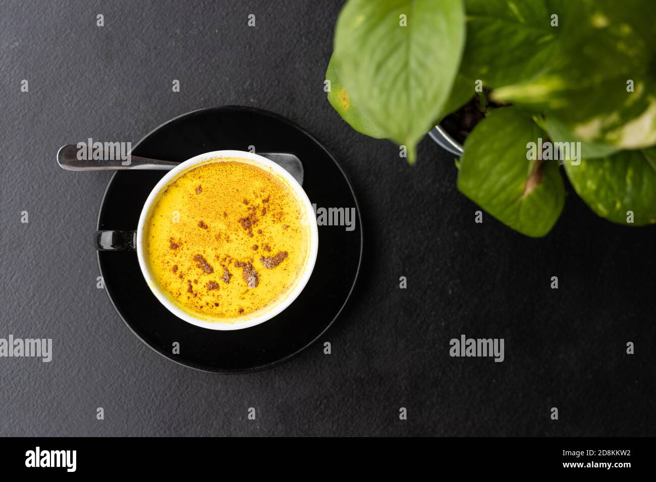 Serving of aromatic turmeric black coffee against dark table Stock