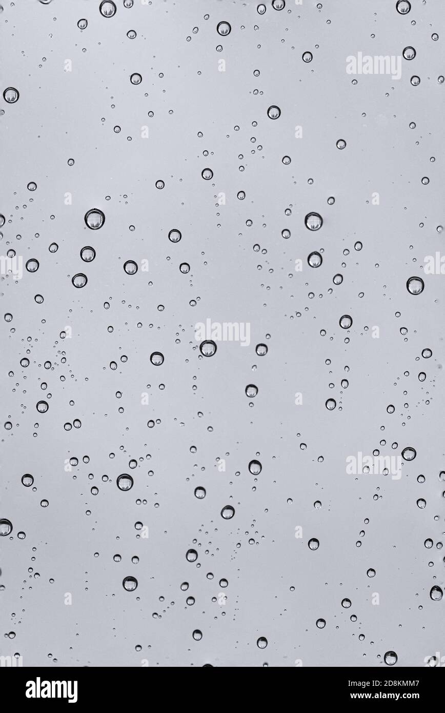Rain water drops  on clear window.  Natural Pattern of raindrops. Autumn  depressive background. Stock Photo