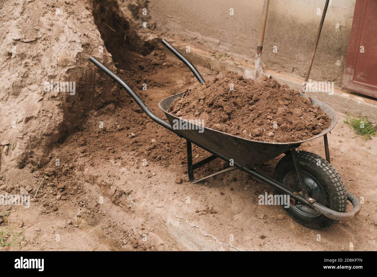 Wheelbarrow full of soil Stock Photo - Alamy