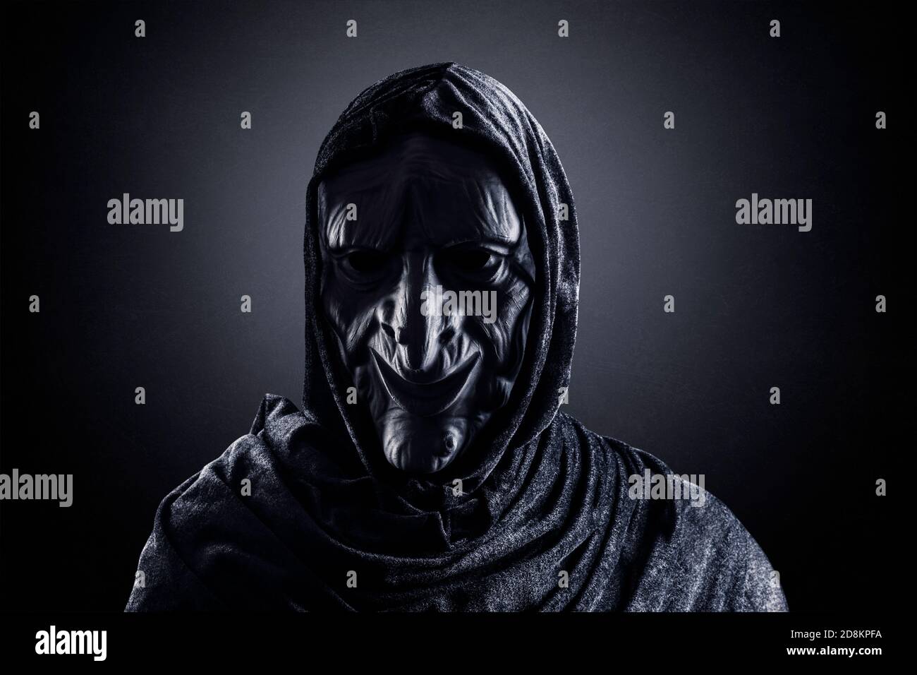 Portrait of a scary witch in hooded cloak Stock Photo - Alamy