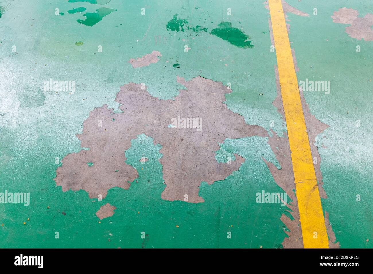Peeling damaged epoxy layered flooring of in garage Stock