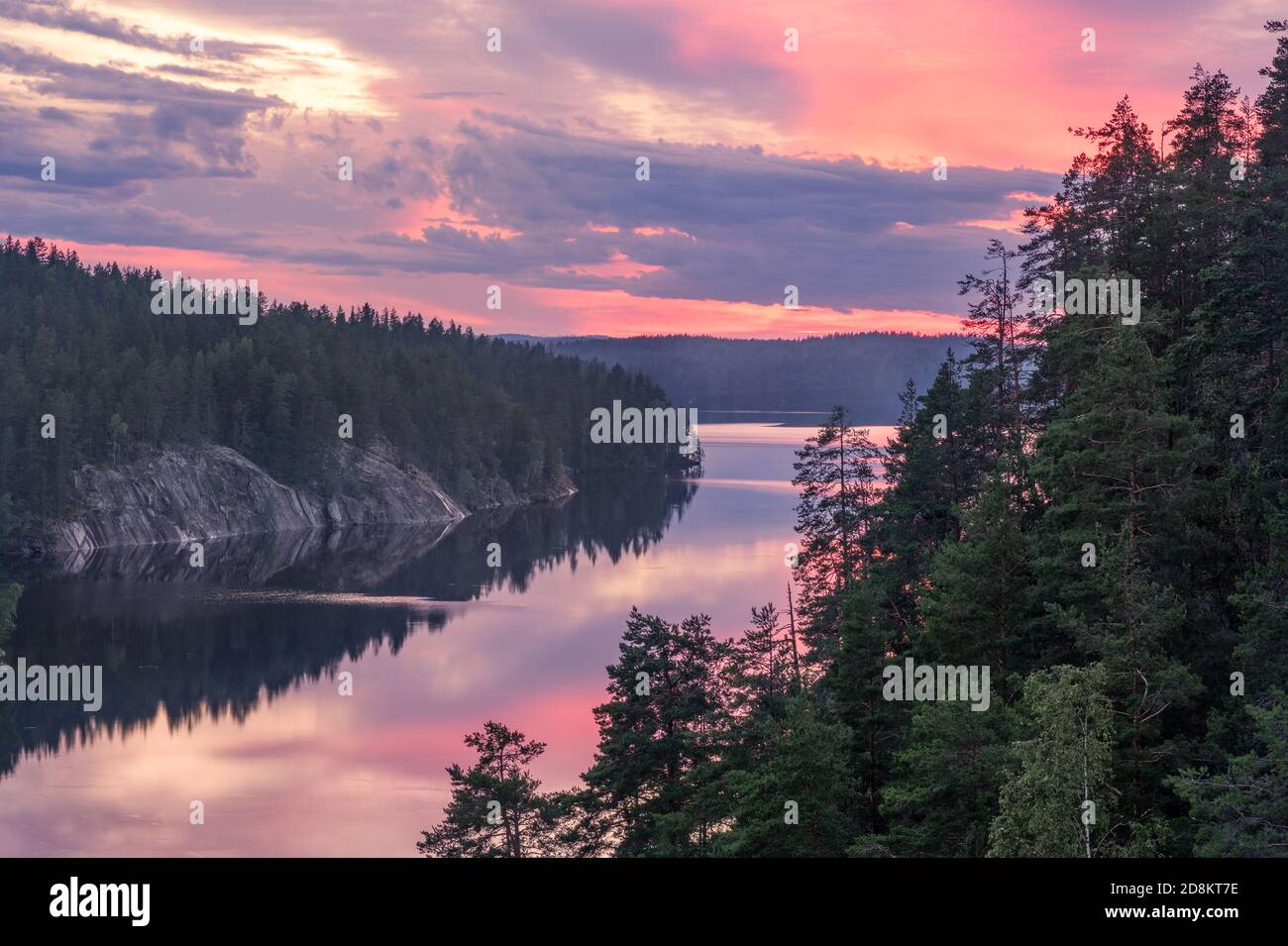 Scenic forest and lake landscape with tranquil mood and colourful sunset at summer morning in Finland Stock Photo