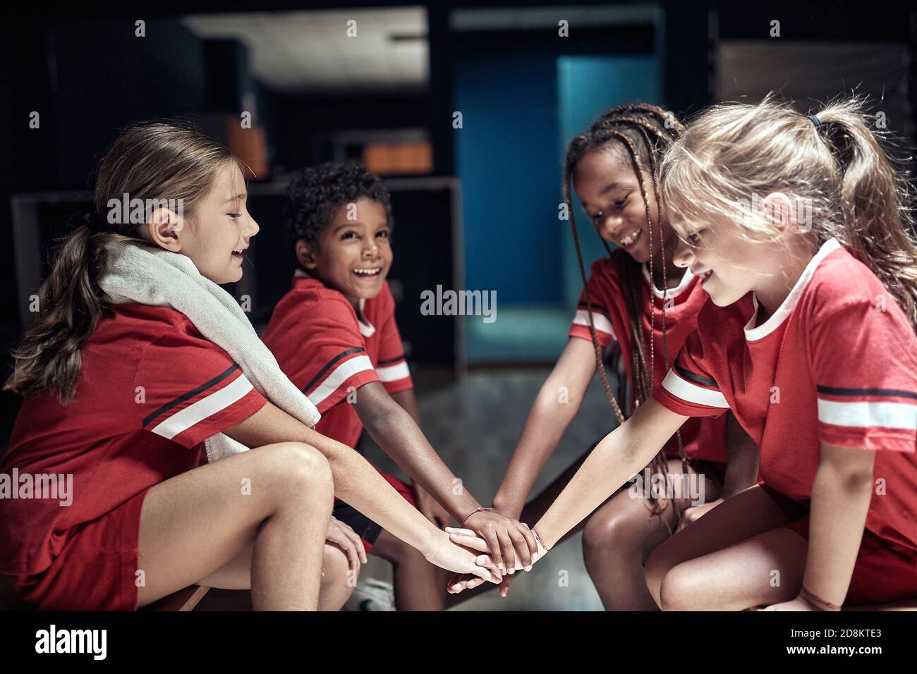 Kids at the locker room building up spirit of togetherness before the  match. Children team sport Stock Photo - Alamy