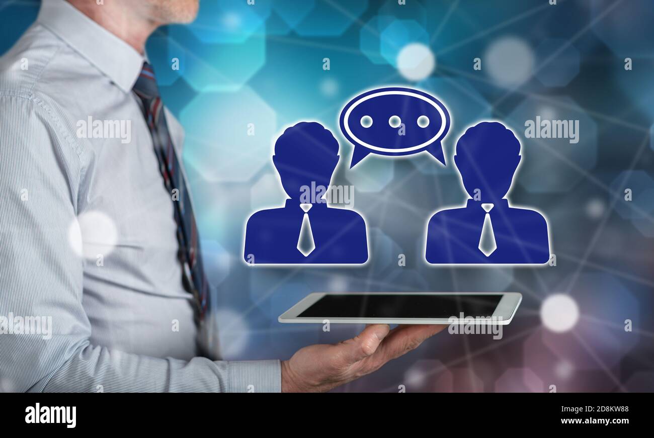 Dialog Tablet Dialogue concept above a tablet held by a man Stock Photo - Alamy