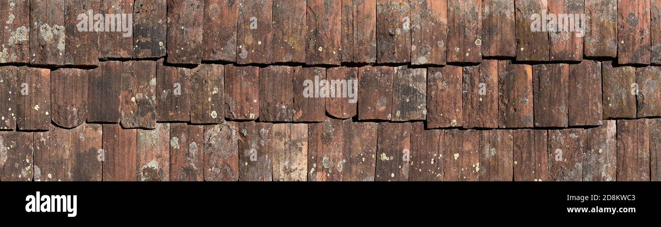 Panoramic closeup of very old roof tiles Stock Photo