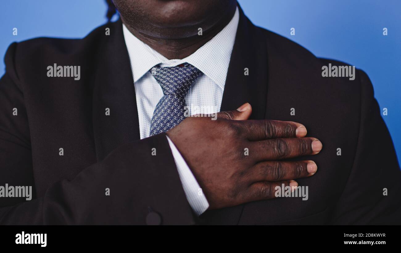 African american black businessman holding hand on his chest. High quality photo Stock Photo