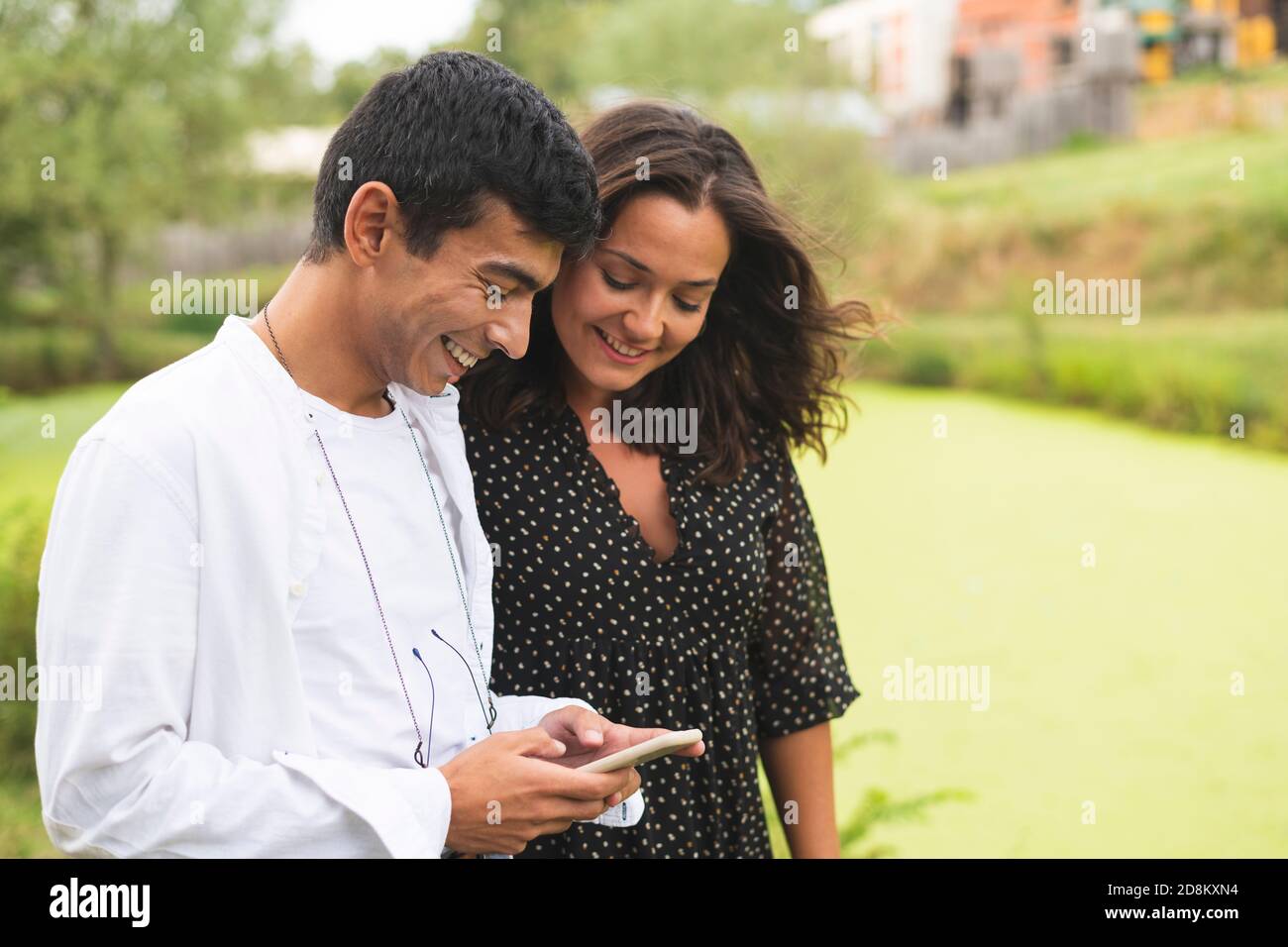 Happy meeting of Two Friends Hugging in a Ranch next to the Lake. Outdoors Concept Photography Stock Photo