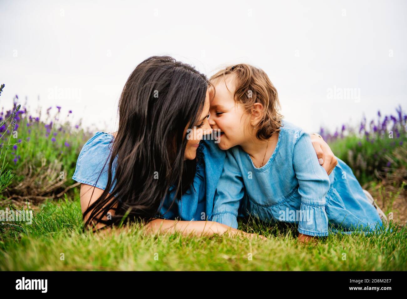 Happy family mother and daughter having fun in lavender field Stock Photo