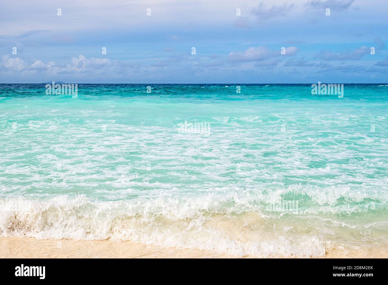 Crystal clear ocean water and shore with blue sky background Stock ...