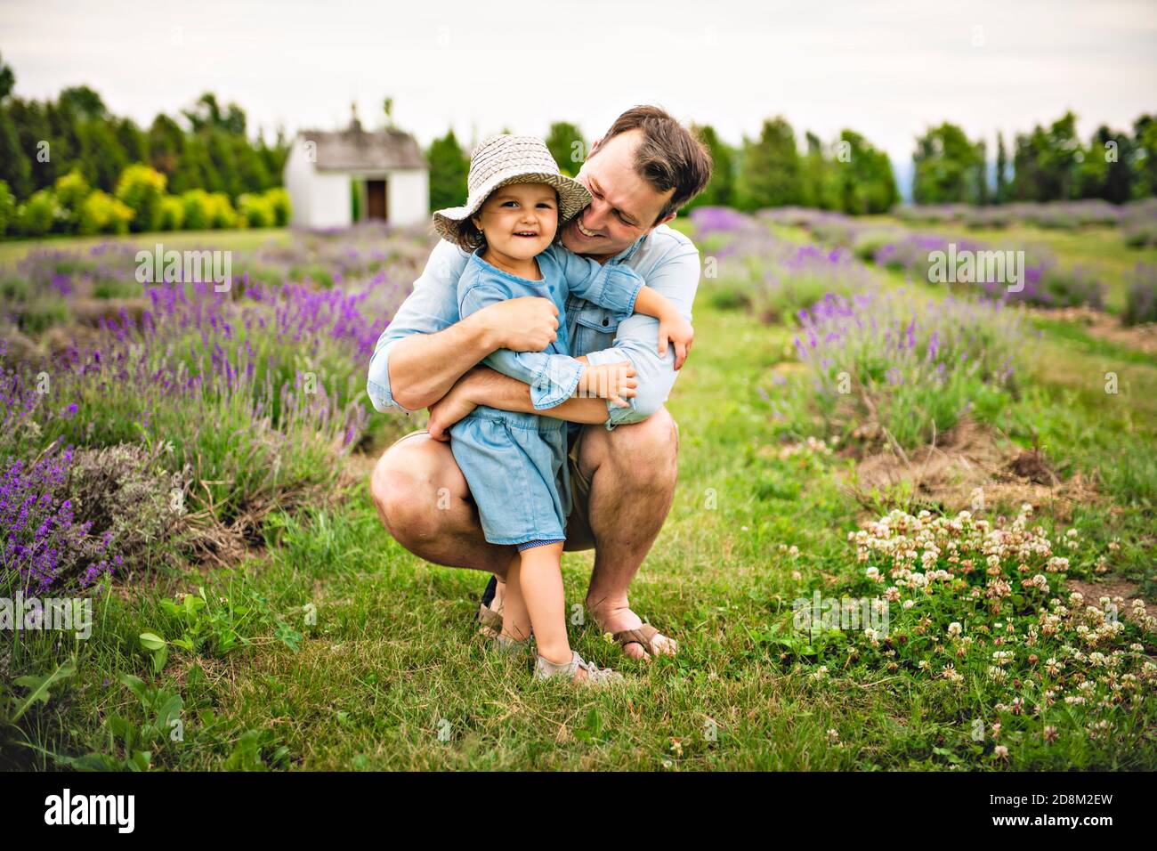 Happy family father and daughter having fun in lavender field Stock Photo