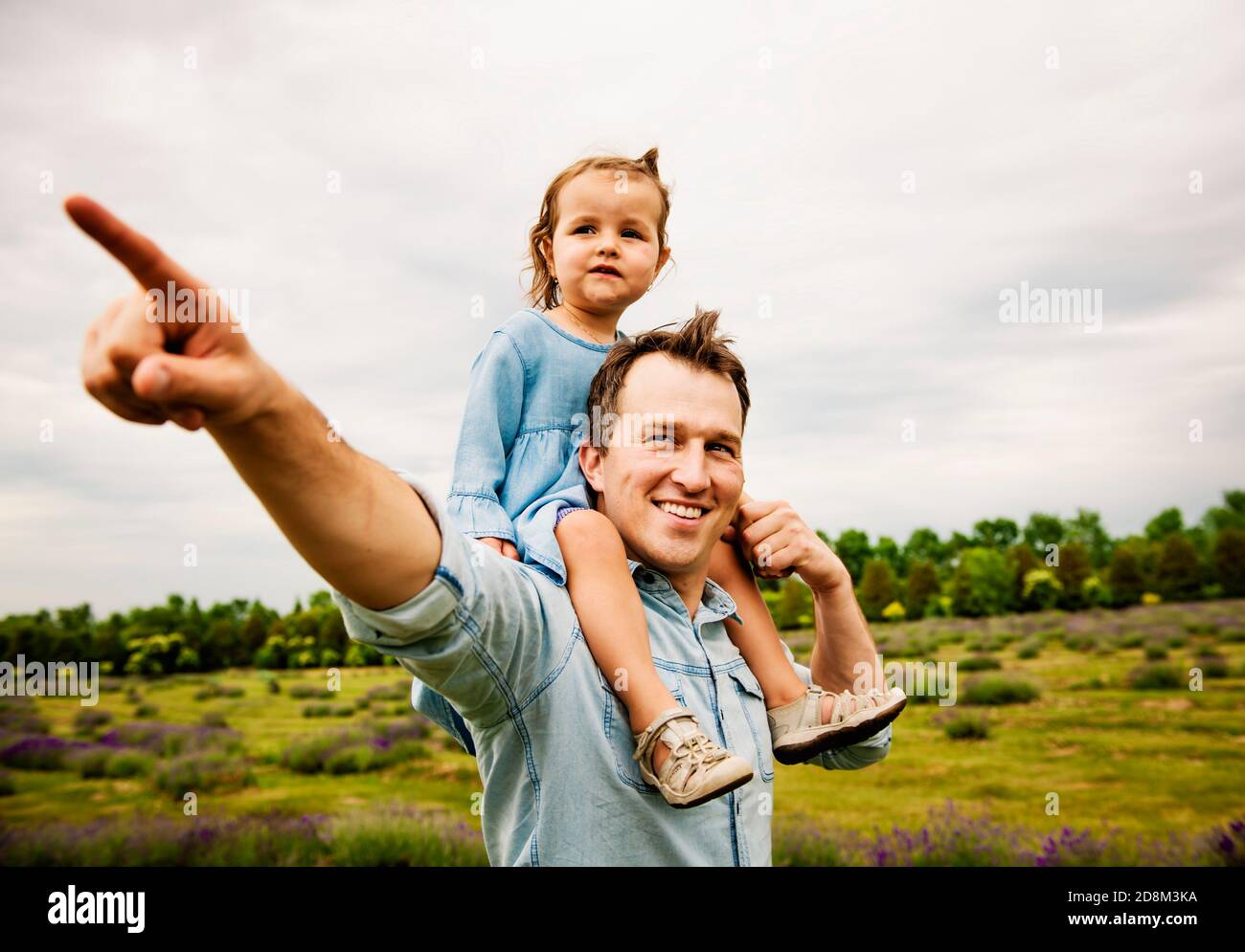 Happy family father and daughter having fun in lavender field Stock Photo