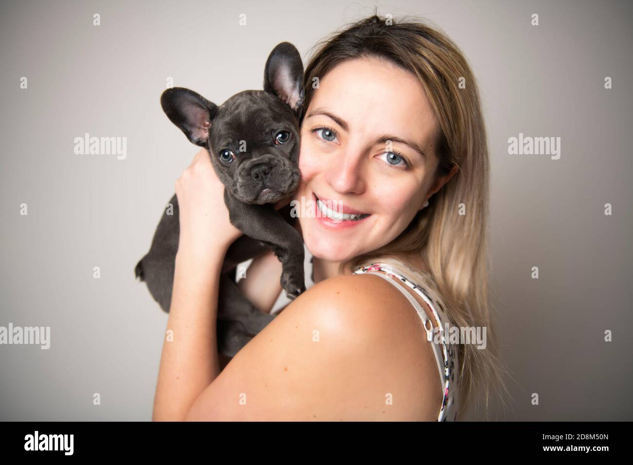 Beautiful woman with french bulldog over white Stock Photo Alamy