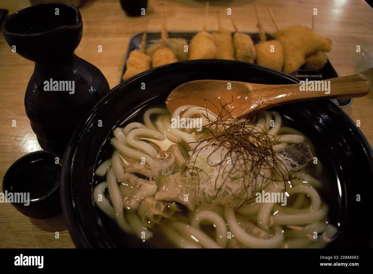 Bowl of Udon noodles with Japanese Sake and Kushikatsu in Tokyo, Honshu, Japan Stock Photo