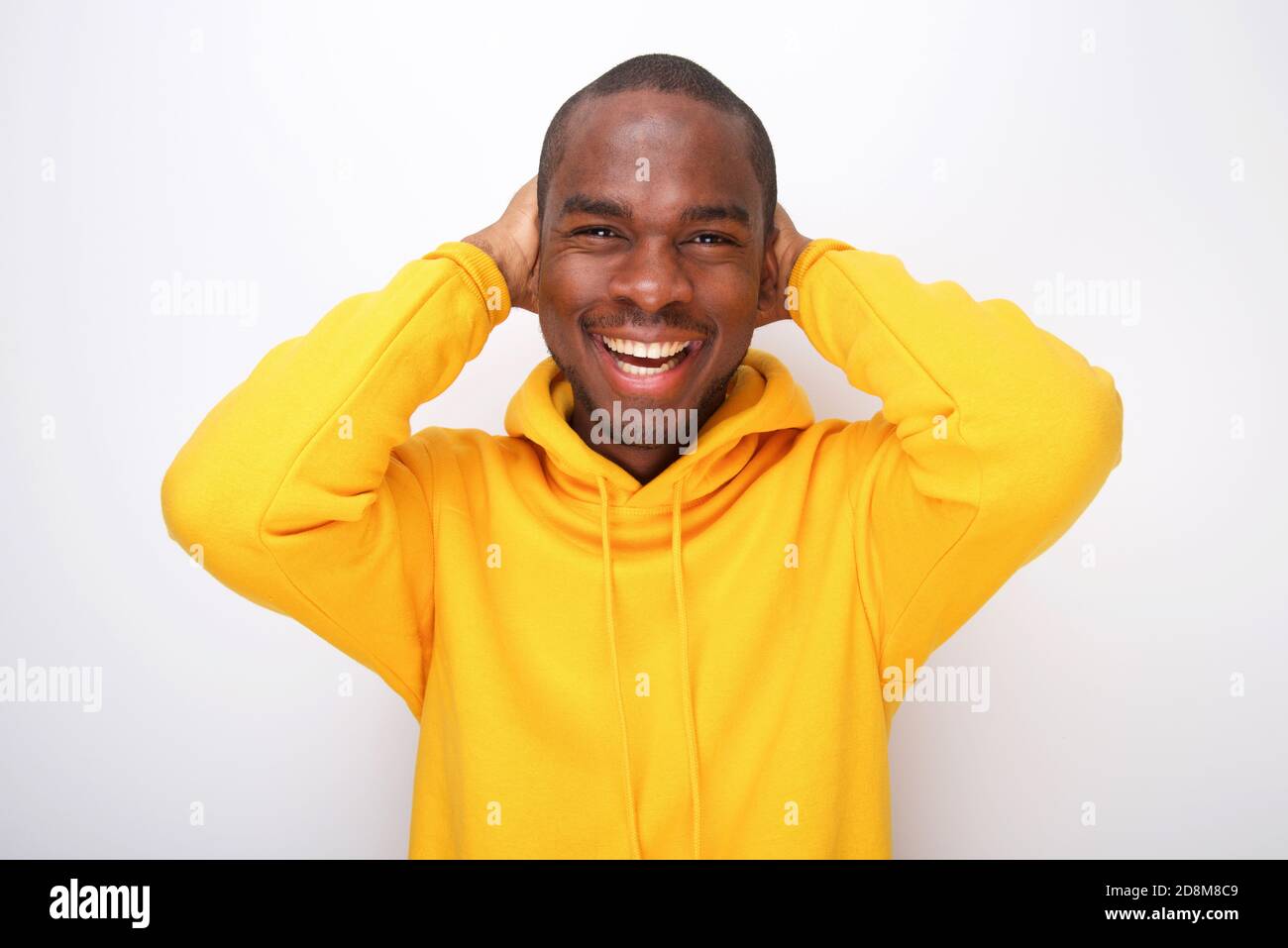 Portrait of happy african american man laughing with hands behind head