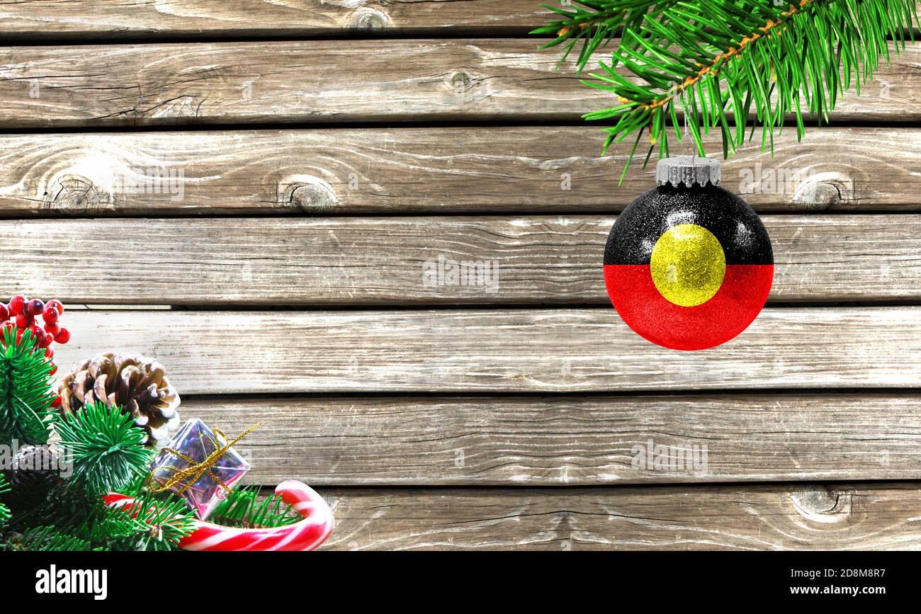 Concept of New Year and Christmas, on a wooden background, Christmas tree branches and a Christmas toy with the flag of Australian Aboriginal Stock Photo - Alamy Concept of New Year and Christmas, on a wooden background, Christmas tree branches and a Christmas toy with the flag of Australian Aboriginal Stock Photo - Alamy