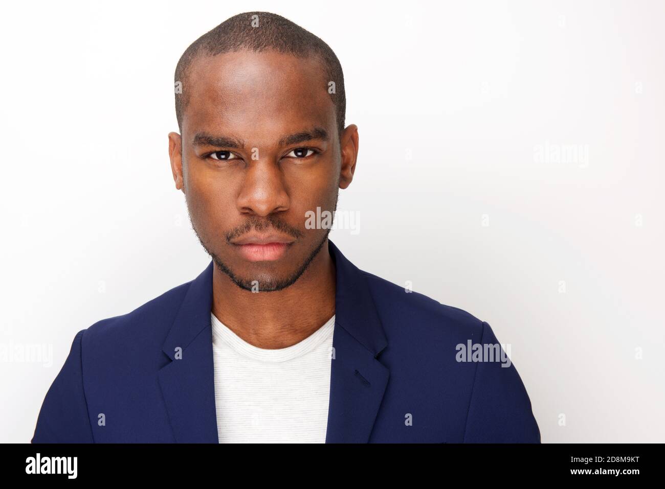 Close up portrait of young black man with staring serious expression ...