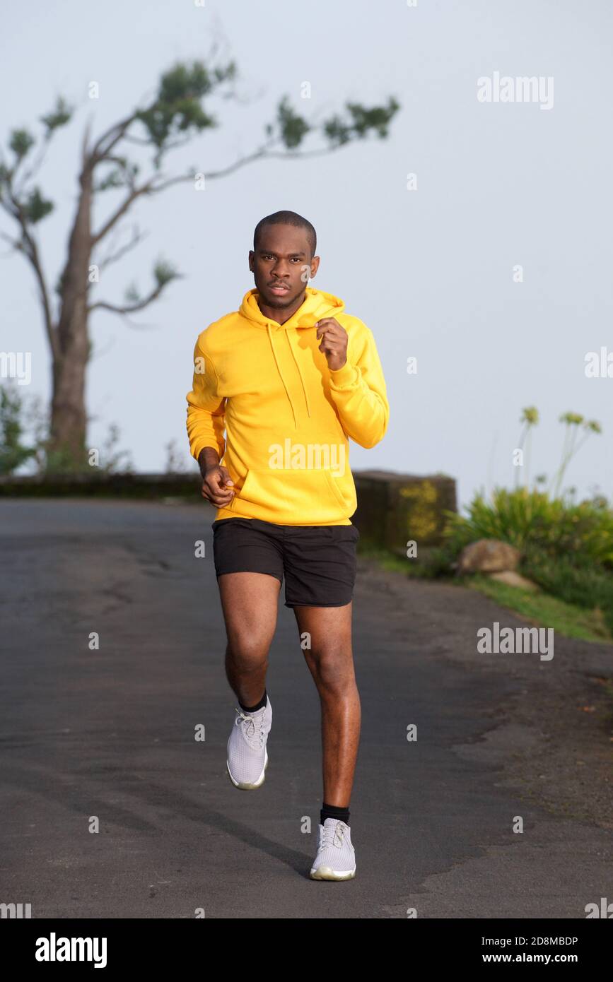 Full body portrait of african american exercise man running on street